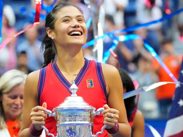 Emma Raducanu of Great Britain celebrates with the championship trophy after her match on day thirteen of the 2021 U.S. Open tennis tournament at USTA Billie Jean King National Tennis Center.