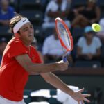 Taylor Fritz returns a shot against Jaume Munar of Spain during the 2022 BNP Paribas Open at Indian Wells Tennis Garden in Indian Wells, California.