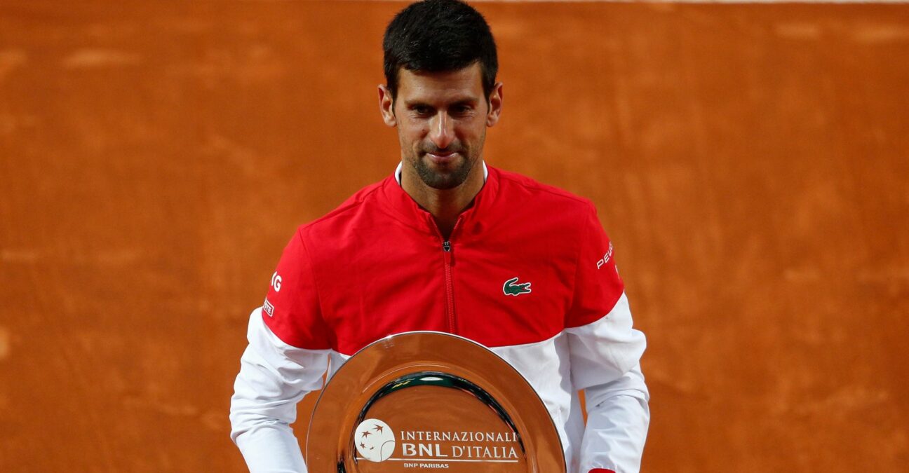 Serbia's Novak Djokovic poses with the runners up trophy after losing against Spain's Rafael Nadal in the final of the Italian Open in Rome