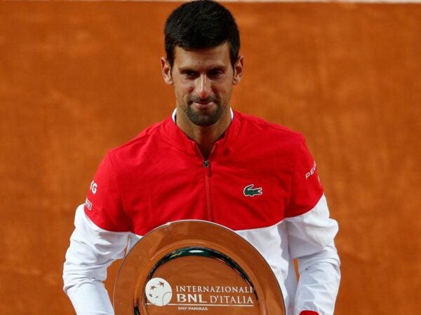 Serbia's Novak Djokovic poses with the runners up trophy after losing against Spain's Rafael Nadal in the final of the Italian Open in Rome