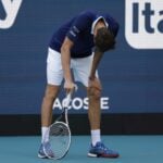 Daniil Medvedev bends over from fatigue after losing a point during his men's singles quarterfinal in the Miami Open at Hard Rock Stadium.