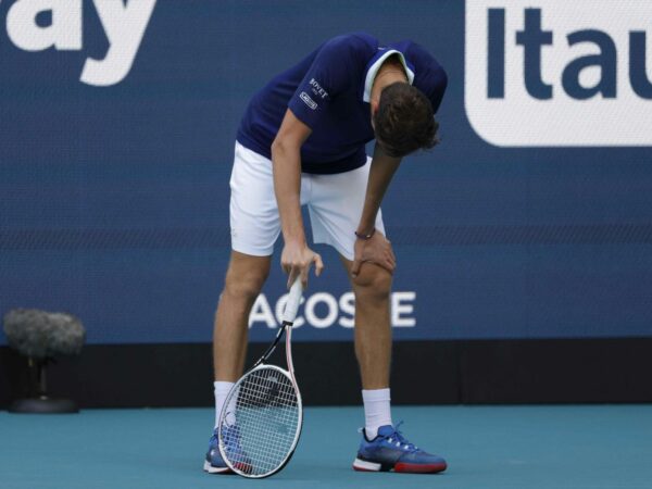 Daniil Medvedev bends over from fatigue after losing a point during his men's singles quarterfinal in the Miami Open at Hard Rock Stadium.