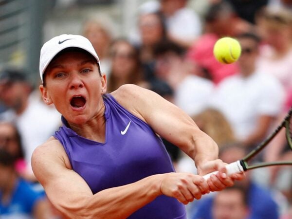 Romania's Simona Halep celebrates winning the first set during her first round match against France's Alize Cornet at the Italian Open