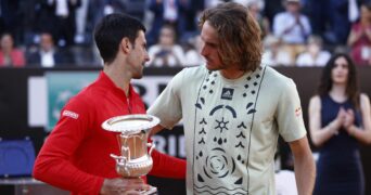 Serbia's Novak Djokovic celebrates with the trophy after winning the final alongside Greece's Stefanos Tsitsipas