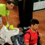 Serbia's Novak Djokovic walks off dejected after losing his quarter final match against Spain's Rafael Nadal at Roland Garros 2022