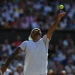 Nick Kyrgios serves during the 2022 Wimbledon final