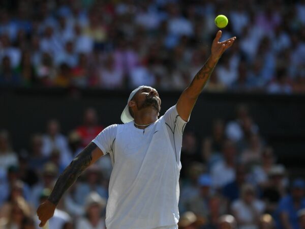 Nick Kyrgios serves during the 2022 Wimbledon final