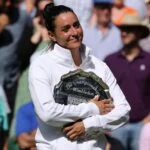 Ons Jabeur (TUN) poses with the runners up plate at the Wimbledon Championships