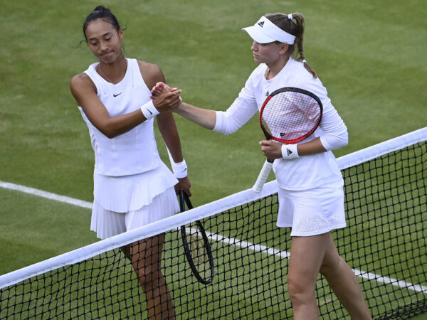 Elena Rybakina shakes hands with China's Qinwen Zheng after winning their third round match at Wimbledon 2022