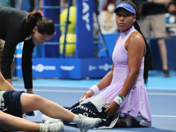 Daria Saville sits on the court as she collapses while Naomi Osaka looks on at the Toray Pan Pacific Open tennis tournament in Tokyo