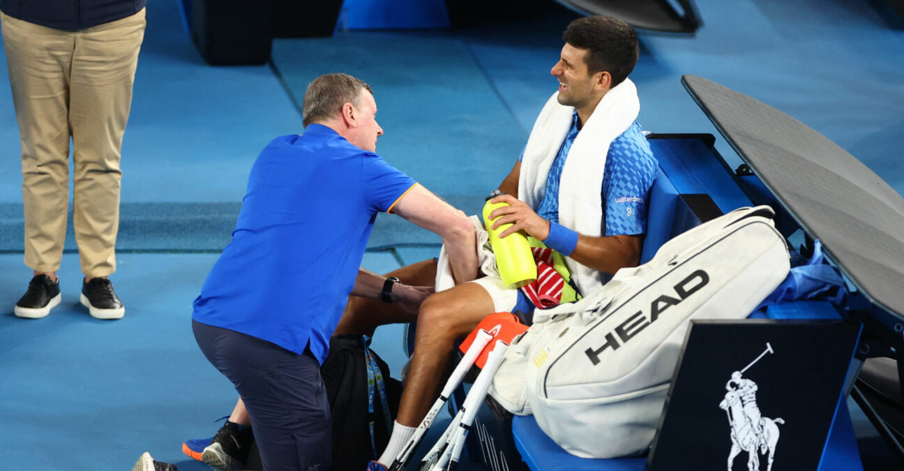 Serbia's Novak Djokovic receives medical attention after sustaining an injury during his third round match against Bulgaria's Grigor Dimitrov at the 2023 Australian Open