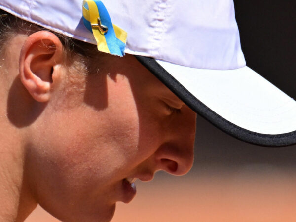 A blue and yellow ribbon in support of Ukraine amid Russia's invasion is pinned to the cap of Poland's Iga Swiatek at the 2022 Italian Open in Rome