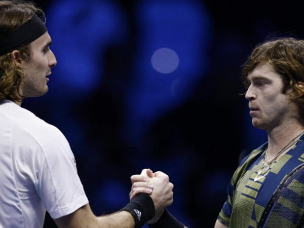 Andrey Rublev shakes hands with Stefanos Tsitsipas after winning their group stage match at the 2022 ATP Finals