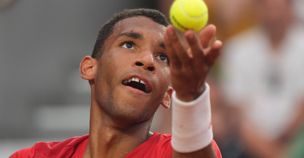 Auger-Aliassime hiting a serve