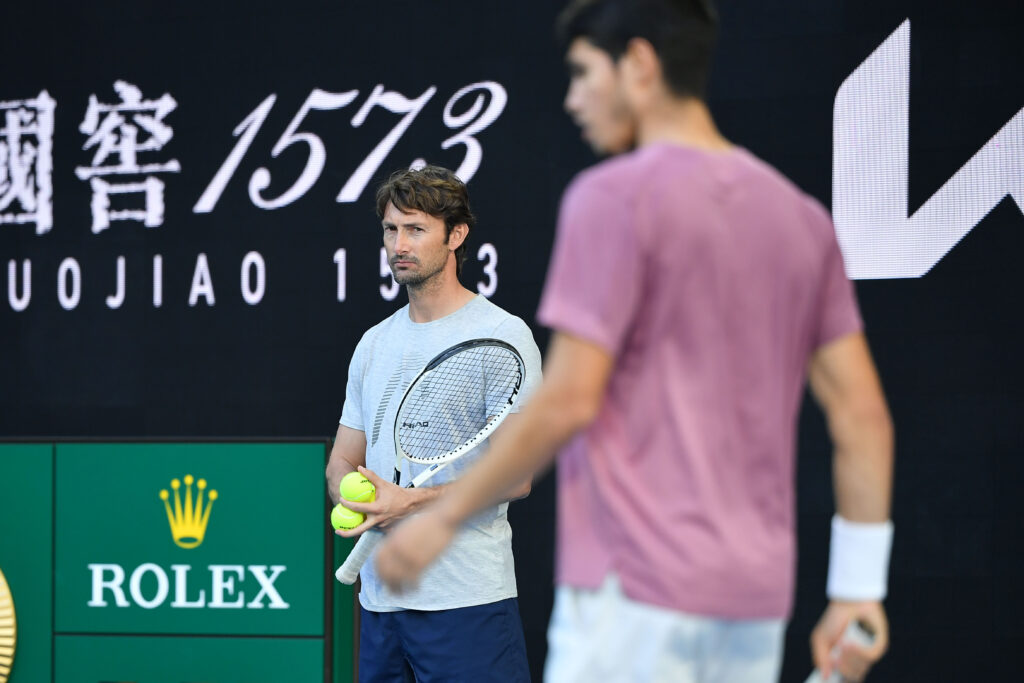 Juan Carlos Ferrero (background) with his player Carlos Alcaraz