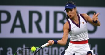 Emma Raducanu (GBR) hits a shot against Aliaksandra Sasnovich (BLR) at Indian Wells Tennis Garden.