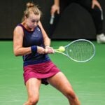 Barbora Krejcikova is hitting a return agains Belina Bencic dureing their semi-final in Tallinn in 2022.