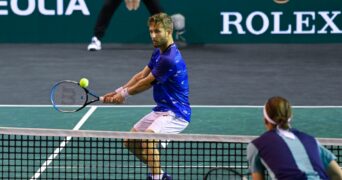 Corentin Moutet hits a backhand passing-shot against Geoffrey Blancaneaux during their match in quallies at the Rolex Paris Masters 2022