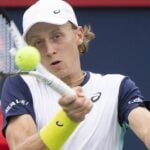 Emil Ruusuvuori hits a forehand return against Stan Wawrinka at Montreal in 2022.