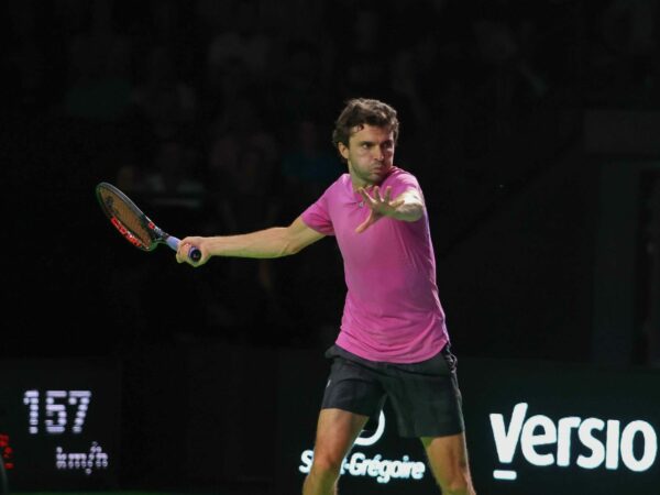 Gilles Simon hits a forehand in the dark at the Rennes Open in 2022