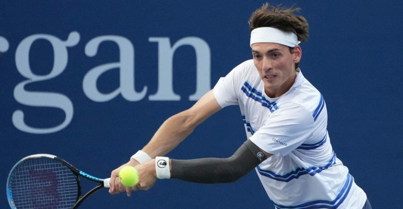 Marc-Andrea Huesler is hitting a backhand against Denis Shapovalov at the US Open 2022