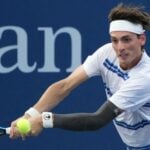 Marc-Andrea Huesler is hitting a backhand against Denis Shapovalov at the US Open 2022