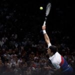 Novak Djokovic hits a serve during the finale of the Rolex Paris Masters 2022 against Daniil Medvedev.