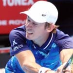 Alex de Minaur hitting a backhand during a match in Tokyo in 2022