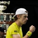 Alex De Minaur celebrates fist Davis Cup trophy Marin Cilic indoor cap